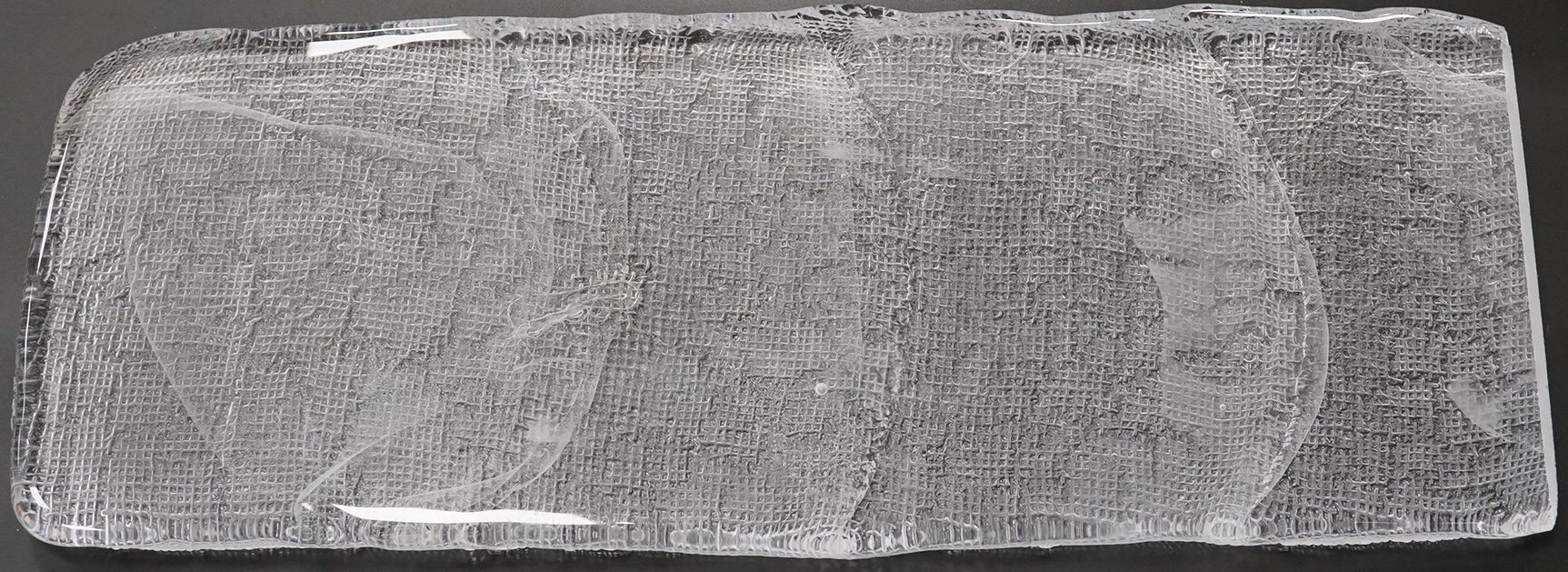 A Mary Canny art glass sandblasted hessian textured glass sculpture, 42cm x 16cm